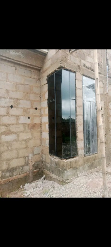 Aluminium window installation on a building site in Nigeria