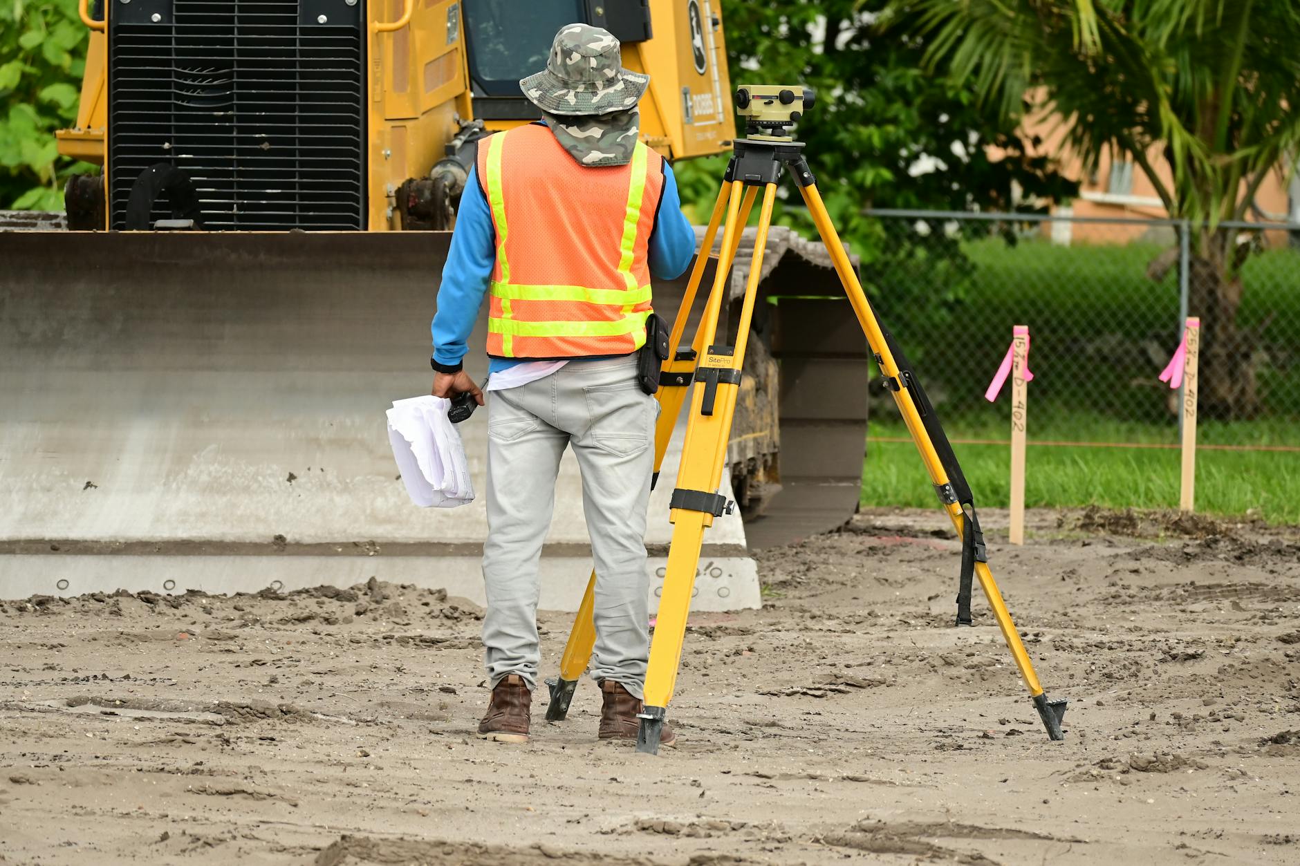 a man in orange and yellow vest Property Survey 