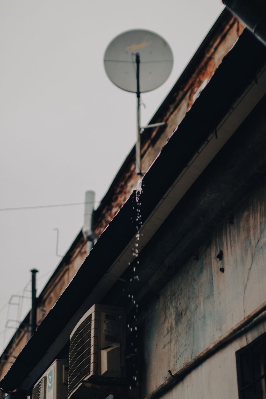 rusty urban rooftop with satellite dish
