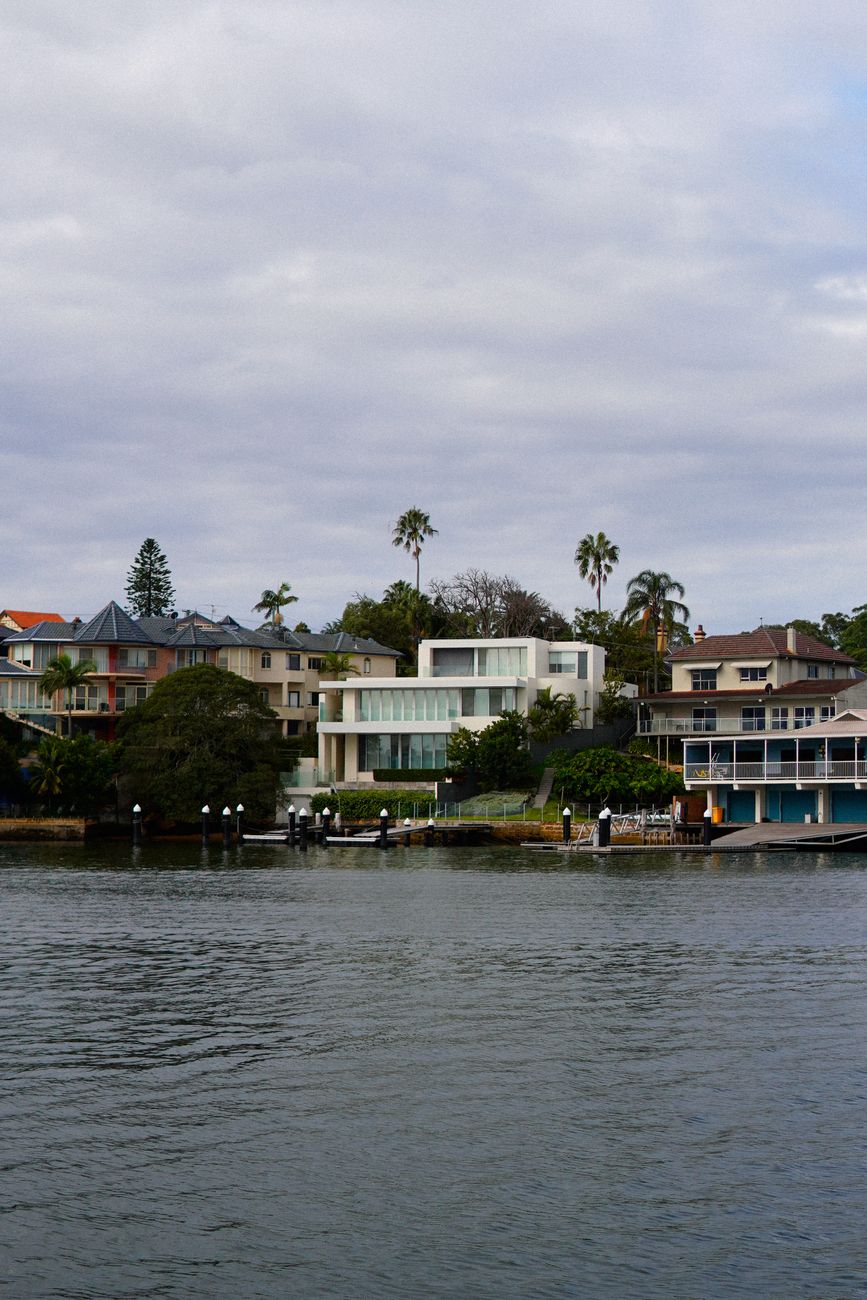 modern coastal homes by riverside with palm trees