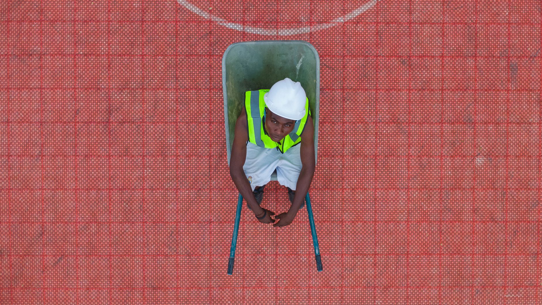 aerial view of construction worker in wheelbarrow